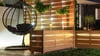 Entspannung pur: Gartenbar mit Holz, Korbstuhl und stimmungsvoller Beleuchtung.